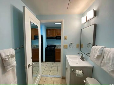 Bathroom with tile patterned flooring, toilet, and vanity