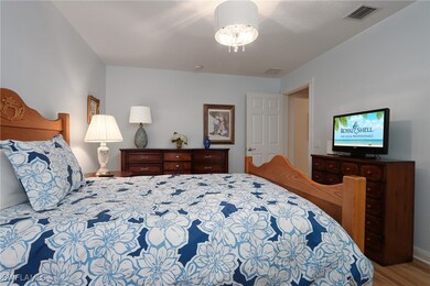 Bedroom with visible vents and wood finished floor