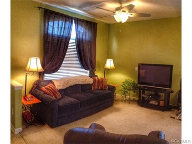 Living room with large window and lighted ceiling 