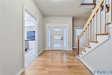 Entryway featuring light wood-type flooring and stairway