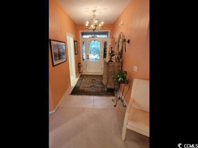 Entryway featuring light colored carpet and a nota
