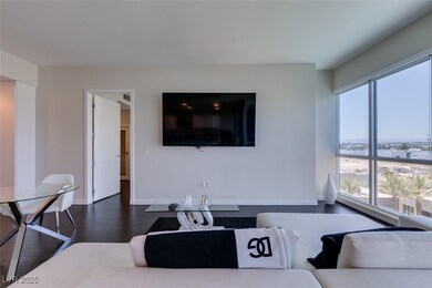 Living room featuring dark wood-style floors and b