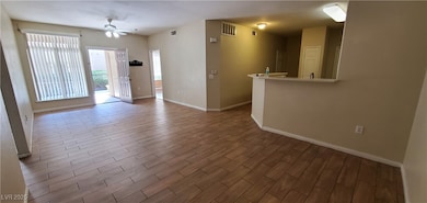 living room with ceiling fan, tile floors, and bas