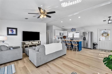 The open floor plan between living room and kitchen makes for easy living and entertaining.