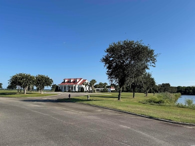 View of asphalt street with a water view and curbs
