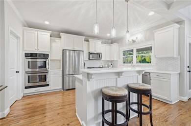 Beautiful white cabinets, updated light fixtures, quartzite countertops