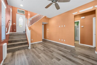 Foyer with visible vents, stairway, and wood finis