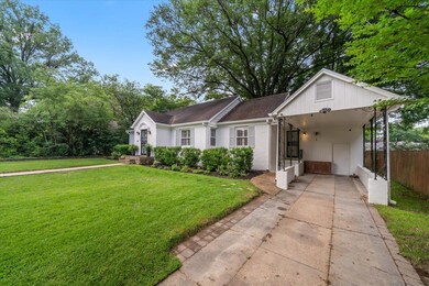 View of front of property with driveway and brick siding