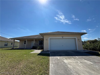 Ranch-style house featuring stucco siding, covered