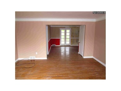 Living Room to Dining Room showing hardwood flooring and French doors to screened in porch.