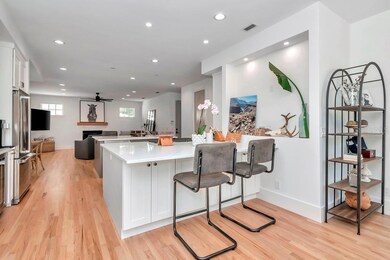 Kitchen has two islands, one with gas cooktop and the other a sink