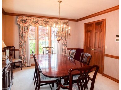 Formal dining room with crown molding and a corner