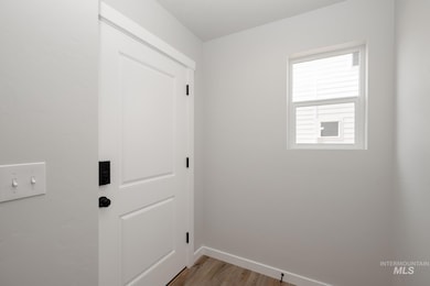 Washroom with light wood-type flooring and baseboards