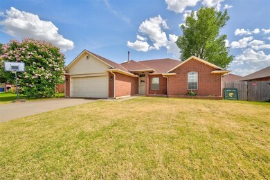 Single story home with a garage and a front yard