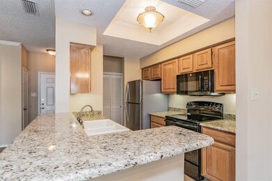 Galley style kitchen with granite counters.