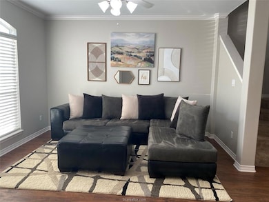 Living room with ceiling fan, wood finished floors