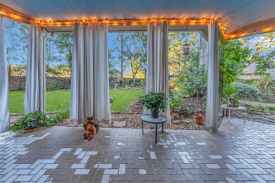 Large patio with white canvas curtains. Great for