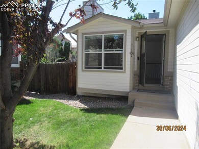 Garage with electric panel, white fridge, and a ga