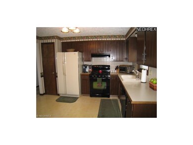 Large kitchen with Shrock cabinets and newer stove and dishwasher.