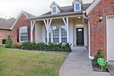 Welcoming covered entrance, has large windows allo