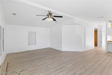 Spacious and sun-filled living area with vaulted ceilings and neutral tones, creating an airy and welcoming atmosphere.