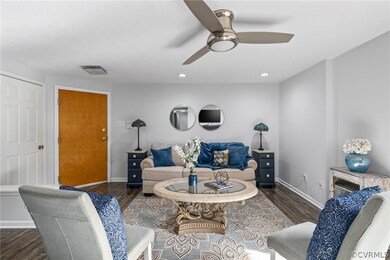 Living room featuring ceiling fan and dark wood-ty
