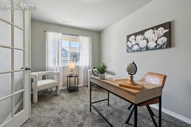 Carpeted office space featuring baseboards