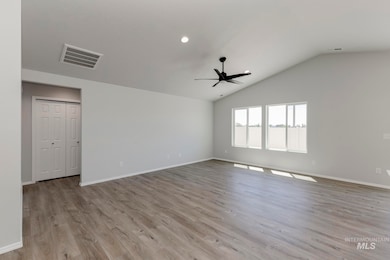 Spare room with light wood finished floors, lofted ceiling, ceiling fan, and recessed lighting
