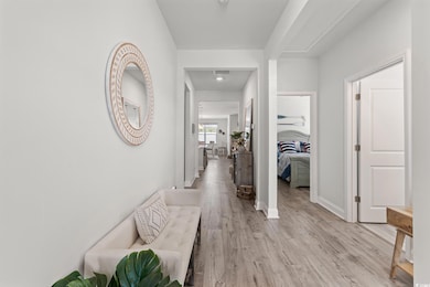 Hall featuring light wood-type flooring and baseboards