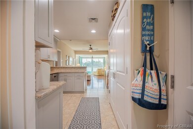 Hallway with light tile patterned floors