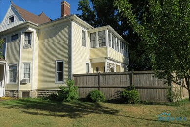 Note the enclosed balcony off the upstairs bedroom