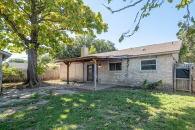 Back of property featuring a lawn and a patio