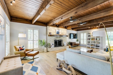 Living room featuring a wooden ceiling with expos