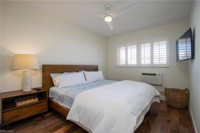 Bedroom featuring a ceiling fan, baseboards, and connected bathroom
