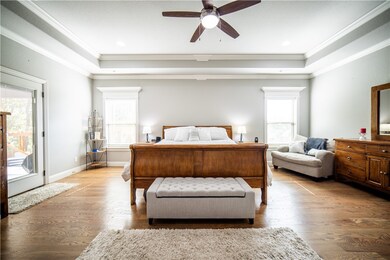 Primary suite is large and has door to back porch