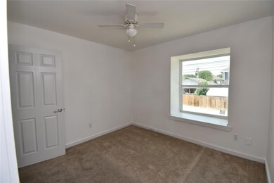 Carpeted empty room featuring baseboards and a ce