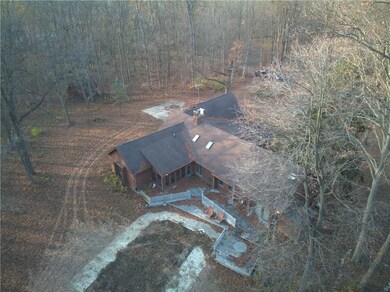 Back of home.  Former pool and deck area offer lots of entertaining space! (leaves will be removed in a couple of days!)