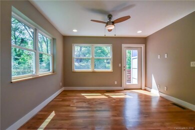 View of living room from dining area, door opens to back deck