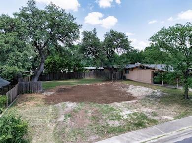 View of yard with driveway and central AC