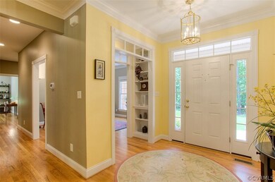 Welcoming Foyer with Crown Molding and Transom Doo