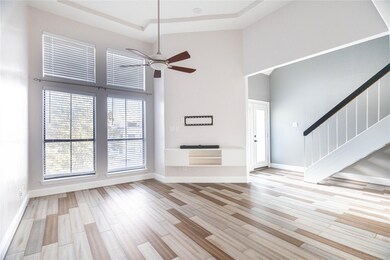 Unfurnished living room featuring ceiling fan, a h