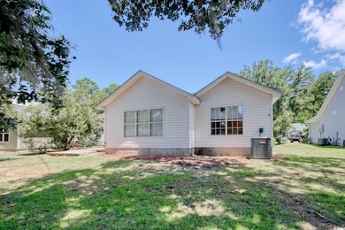 Back of house with a yard