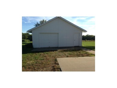 Room for third car or equipment.  Concrete floor, 