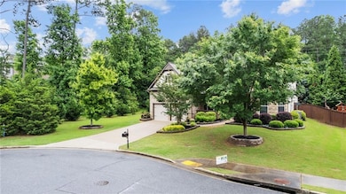 Obstructed view of property featuring concrete driveway and view of scattered trees