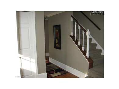 Spacious Foyer with turned stairway and large coat