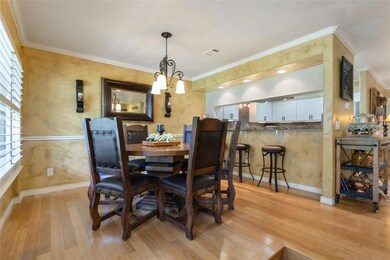 Dining room with light wood-style flooring, baseb