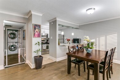 Dining room with stacked washer and clothes dryer,