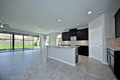 Grand Family Room is open and flows so gently into your Gourmet Kitchen and Casual Dining!  Wait till you open that Huge Disappearing Sliding Glass Door to allow the Outside come inside!  Stunning feature that you will love!