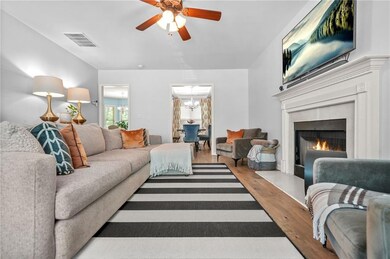 Living area with a chandelier, wood finished floor