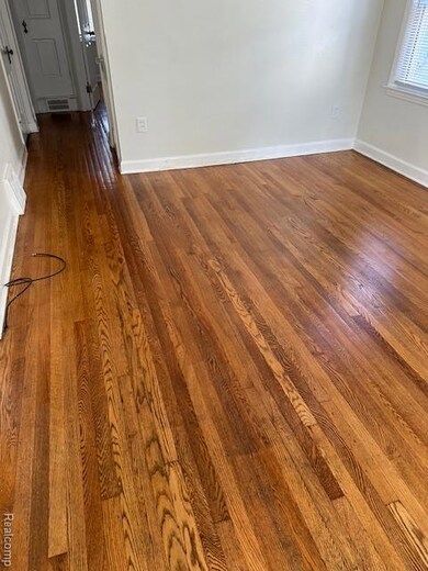 Detailed view of wood finished floors and baseboards